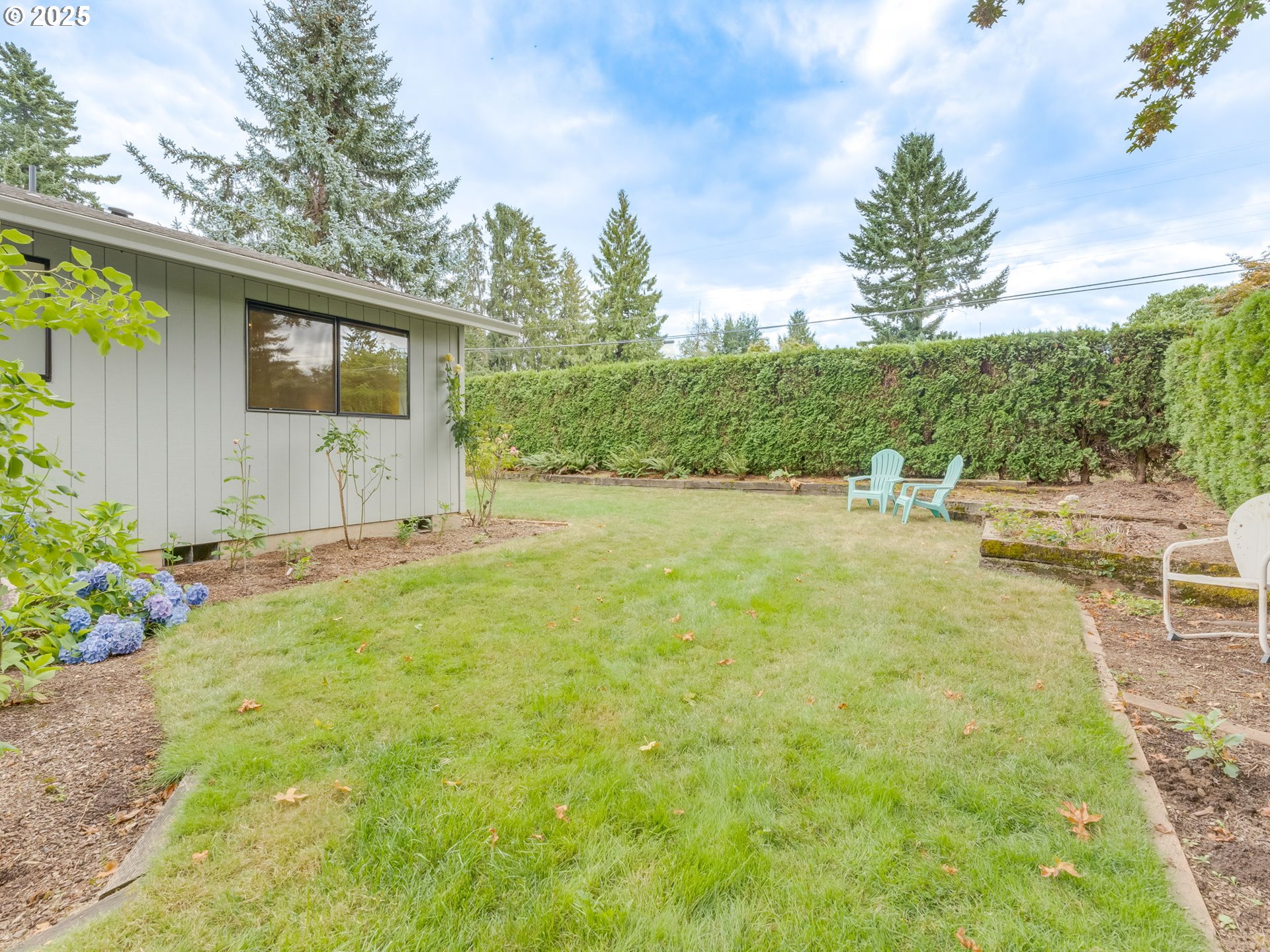 17925 Beebee Court Sandy, OR 97055 - Photo 44 of 48 a backyard of a house with table and chairs plants and large trees