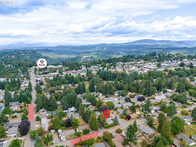 an aerial view of a houses with city view