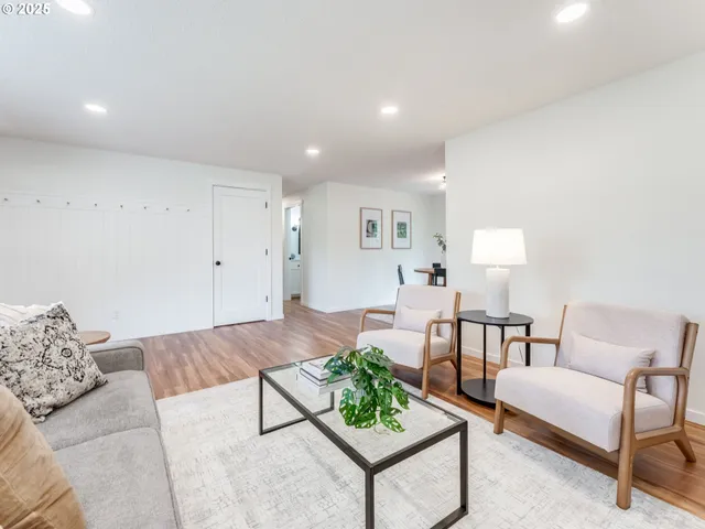 a living room with furniture and a potted plant on table