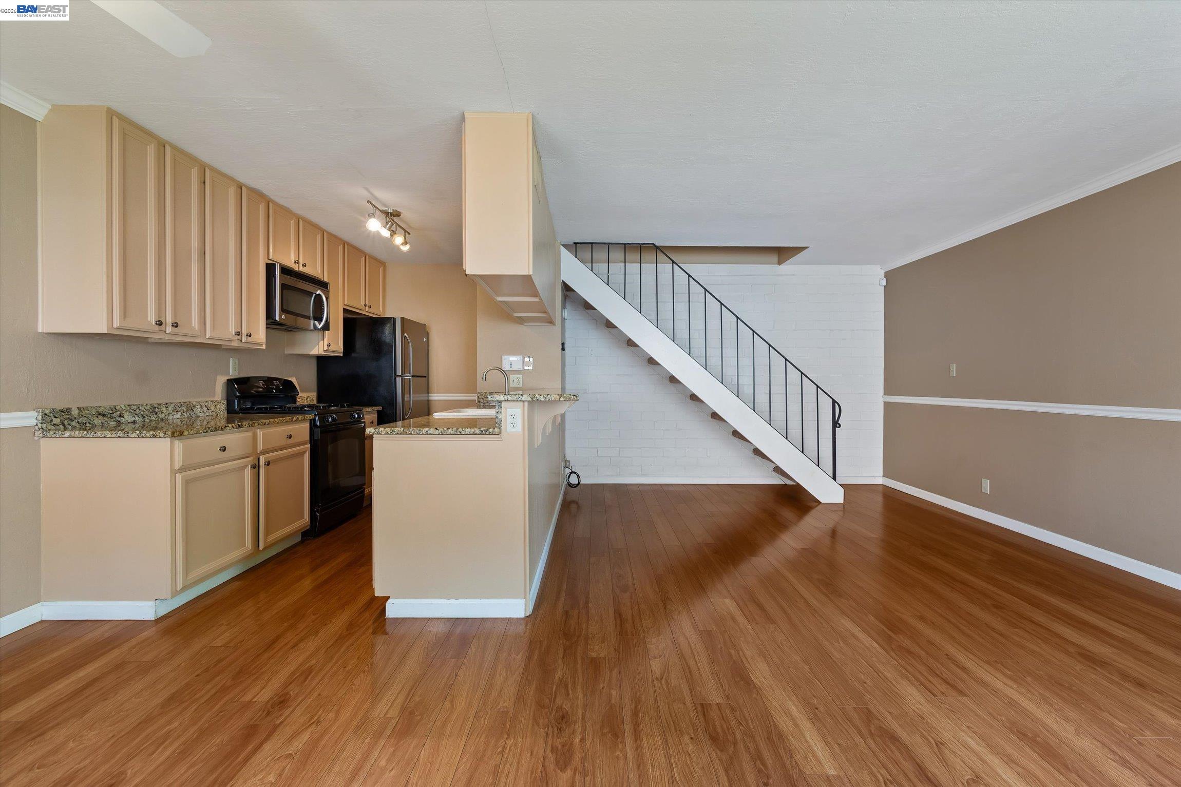 2243 Segundo Court, Unit 2 Pleasanton, CA 94588 - Photo 7 of 22 a view of a kitchen with wooden floor and electronic appliances