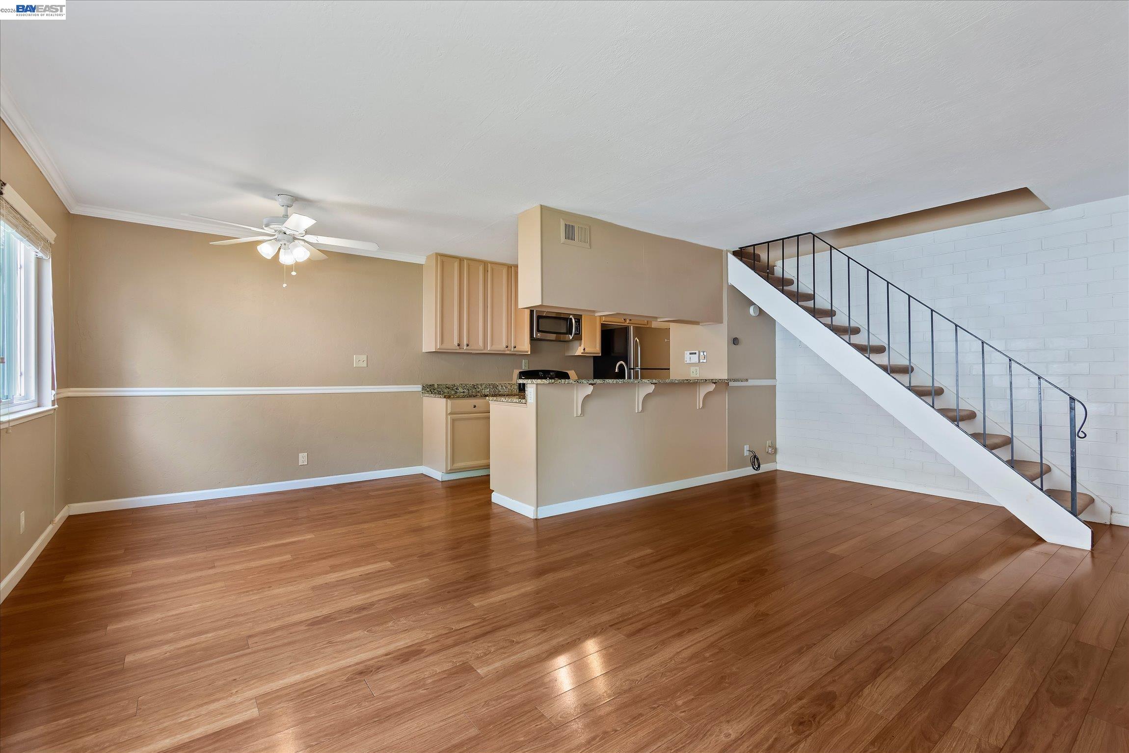 2243 Segundo Court, Unit 2 Pleasanton, CA 94588 - Photo 8 of 22 a view of a kitchen with wooden floor and electronic appliances