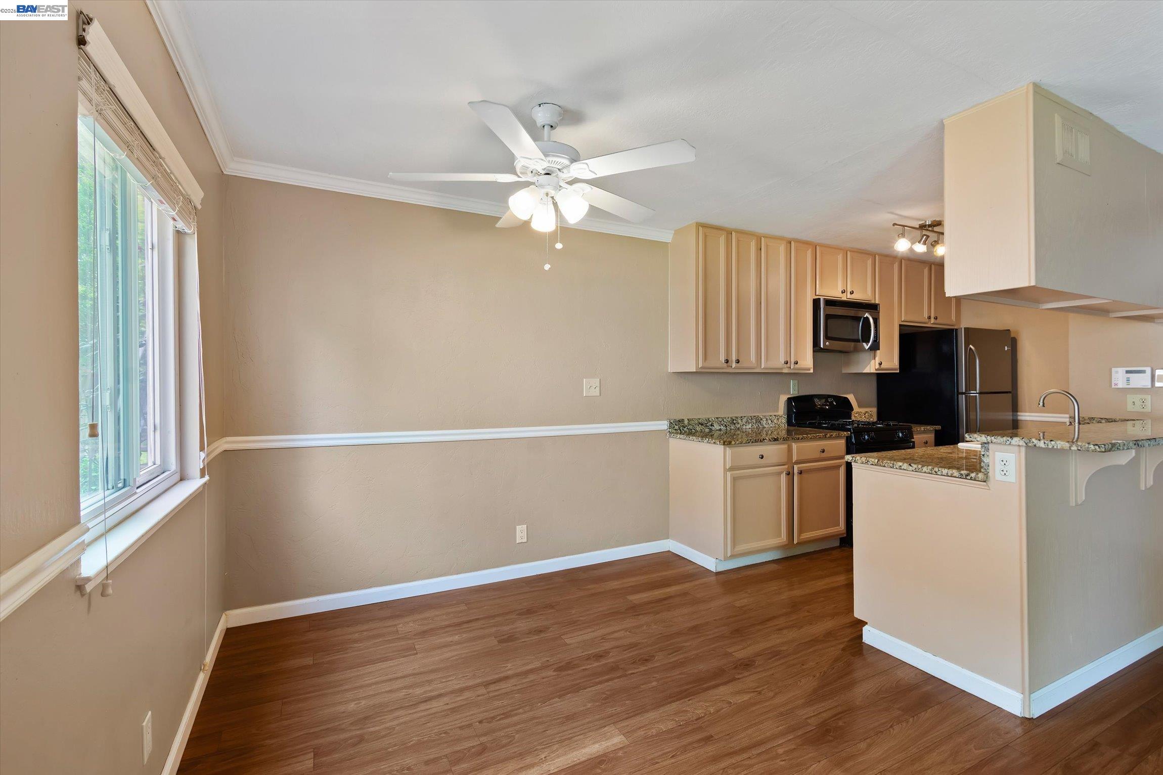 2243 Segundo Court, Unit 2 Pleasanton, CA 94588 - Photo 9 of 22 a kitchen with a refrigerator cabinets and wooden floor