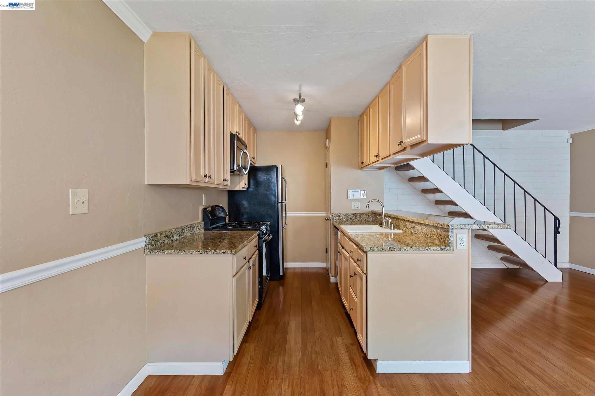 2243 Segundo Court, Unit 2 Pleasanton, CA 94588 - Photo 10 of 22 a view of a kitchen with wooden floor and electronic appliances