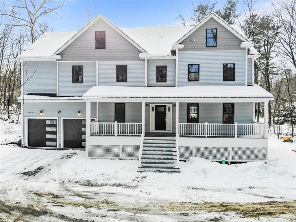 68 Wilmington Road Burlington, MA 01803 - Photo 1 of 42 a front view of a house with a yard covered in snow