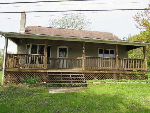 a view of a house with a small yard and wooden fence