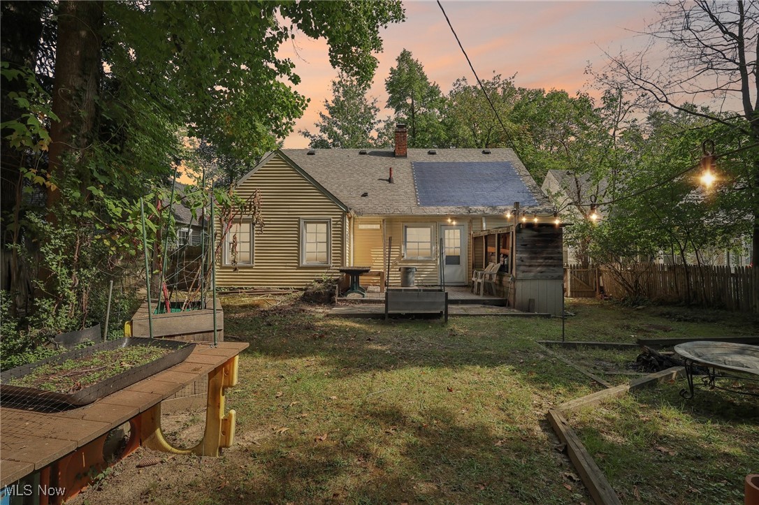 1042 Renfield Road Cleveland Heights, OH 44121 - Photo 46 of 49 Back house at dusk with a wooden deck and a lawn