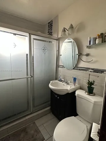 a bathroom with a sink toilet and mirror
