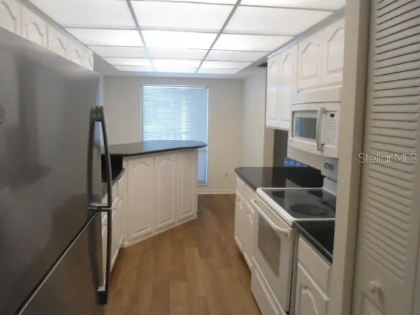 a kitchen with a sink and a refrigerator