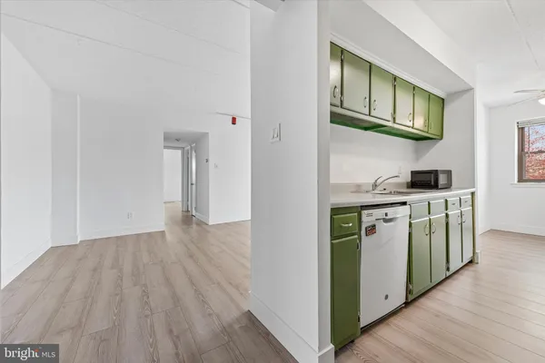 a kitchen with stainless steel appliances granite countertop a stove and a wooden floors
