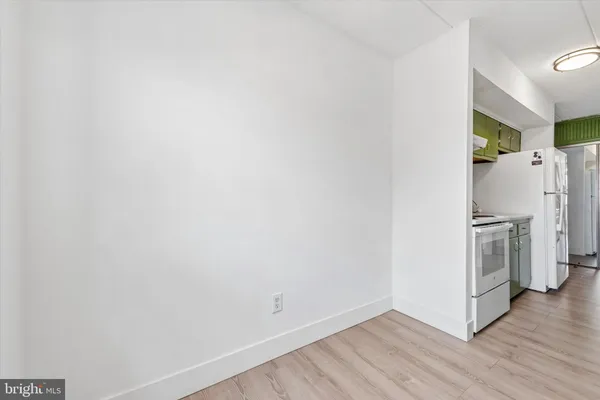 a view of a refrigerator in kitchen and wooden floor