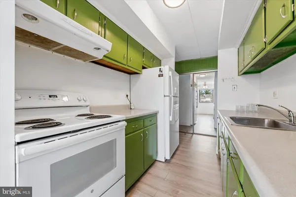 a kitchen with a sink cabinets and stainless steel appliances