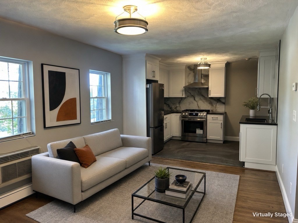 18 Ashcroft Street, Unit 301 Dedham, MA 02026 - Photo 1 of 14 a living room with furniture and a rug