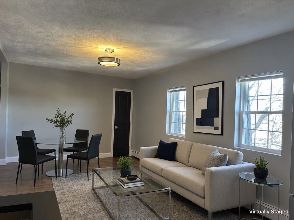 18 Ashcroft Street, Unit 301 Dedham, MA 02026 - Photo 2 of 14 a living room with furniture and windows