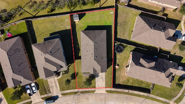 an aerial view of a house with a street