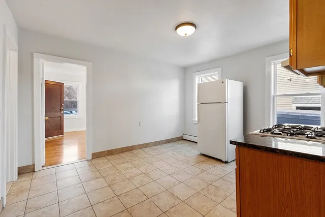 a kitchen with a stove a sink and a refrigerator