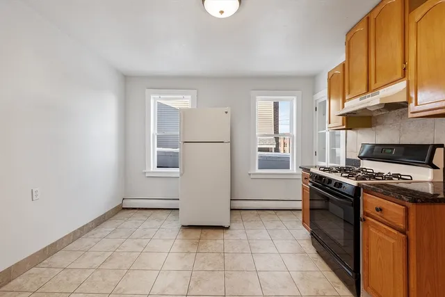 a kitchen with a refrigerator a stove a microwave and a counter top space