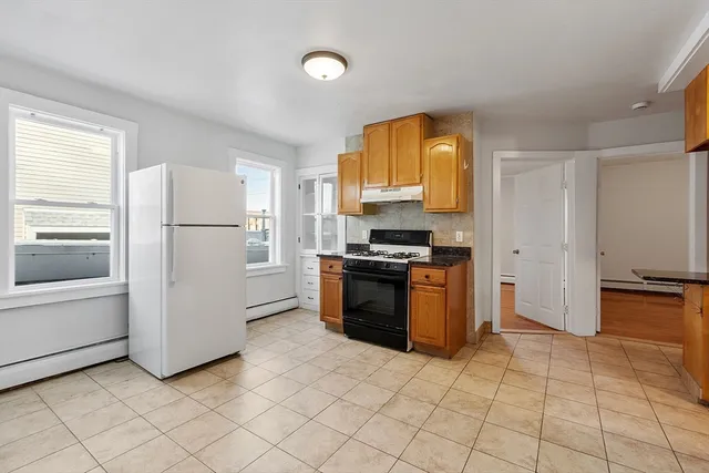 a kitchen with stainless steel appliances granite countertop a stove a refrigerator and a microwave
