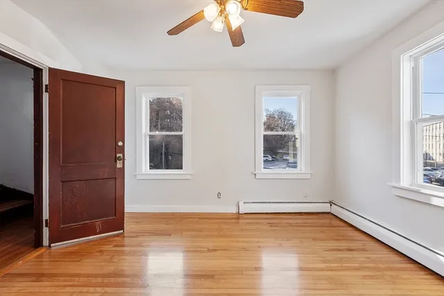 an empty room with wooden floor and closet