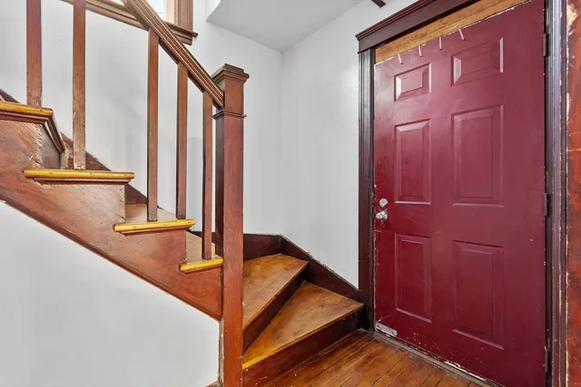 a view of a room with wooden floor and a window