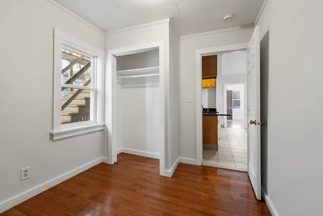 a view of an empty room with wooden floor