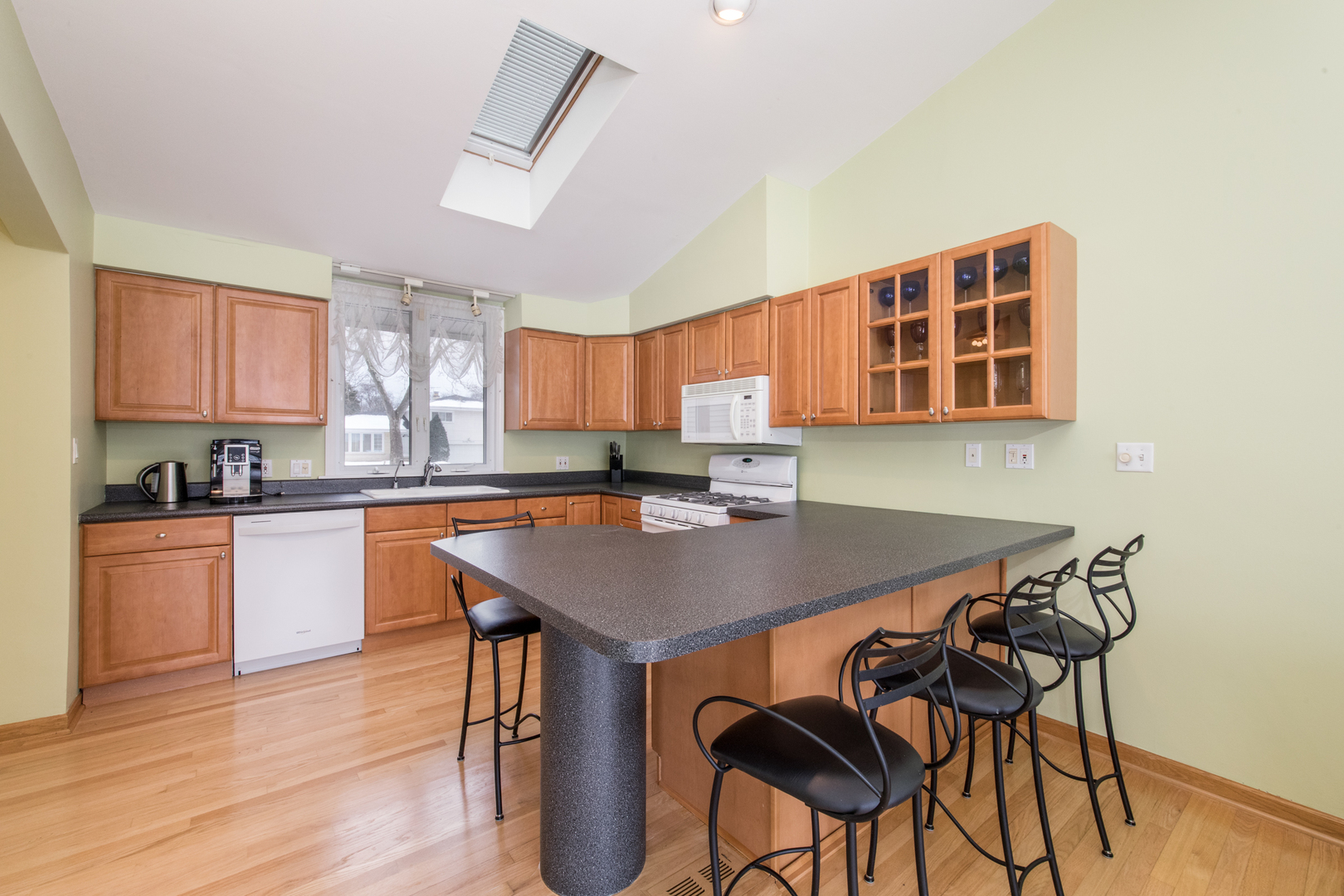 2010 Walnut Street Park Ridge, IL 60068 - Photo 3 of 20 a kitchen with a table chairs a sink dishwasher stove and cabinets with wooden floor
