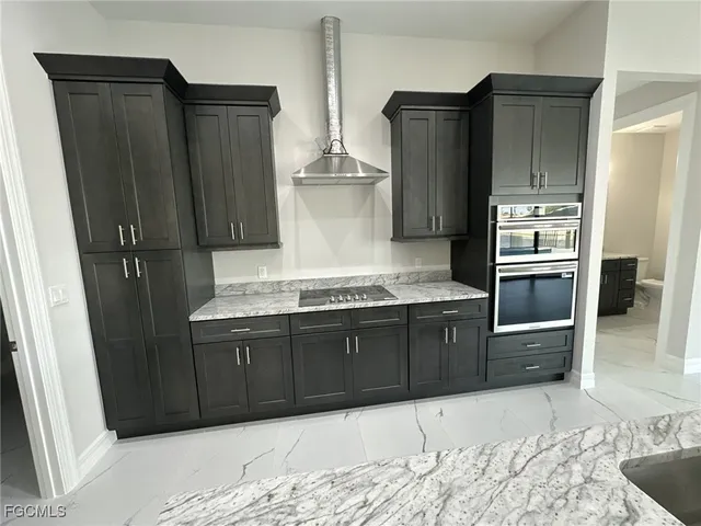 a kitchen with stainless steel appliances granite countertop a refrigerator and a sink