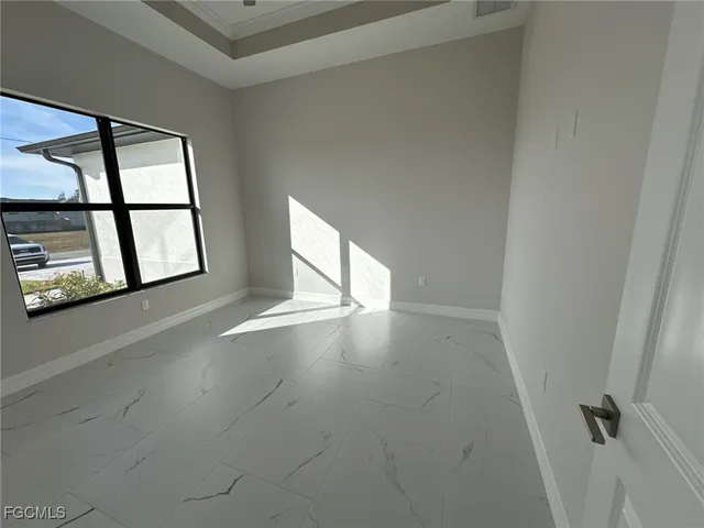 an empty room with windows and entrance