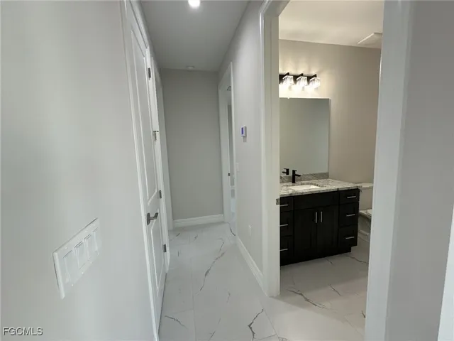 a spacious bathroom with a bathtub sink and mirror