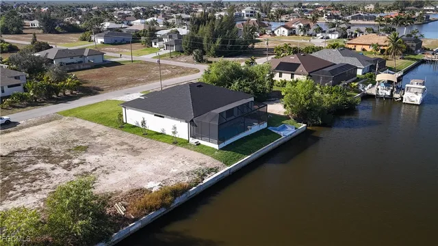 an aerial view of residential houses with outdoor space and swimming pool