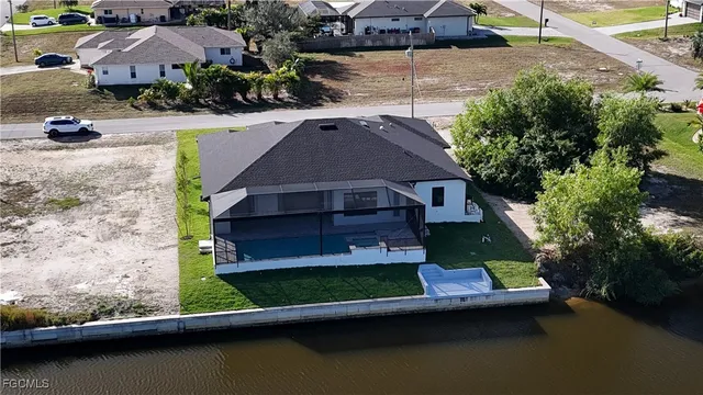 an aerial view of a house with a yard