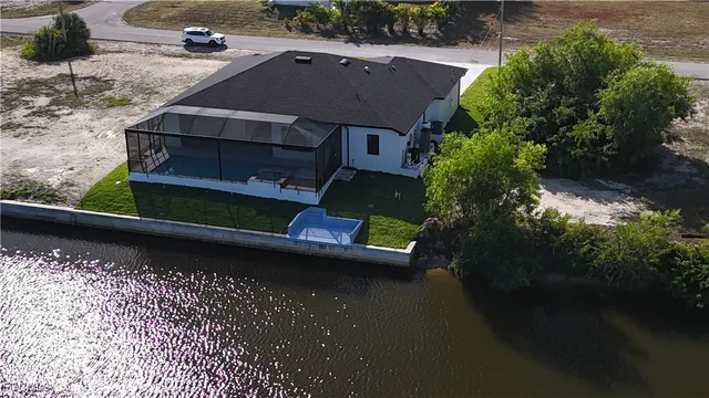 an aerial view of a house with a yard