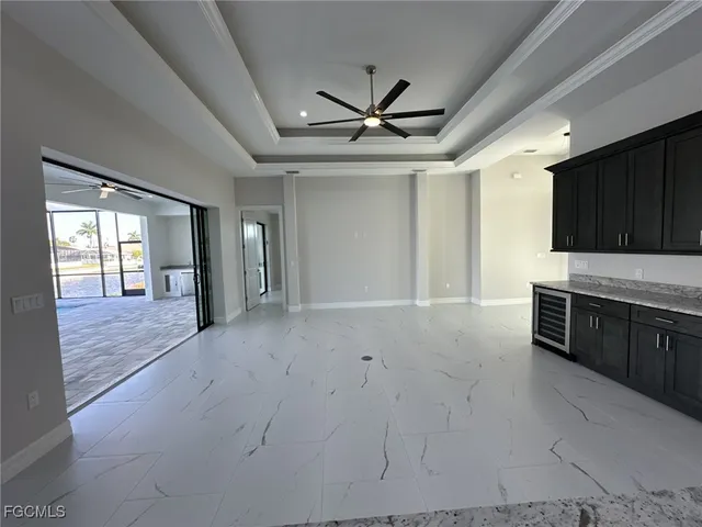 a view of an empty room with a kitchen