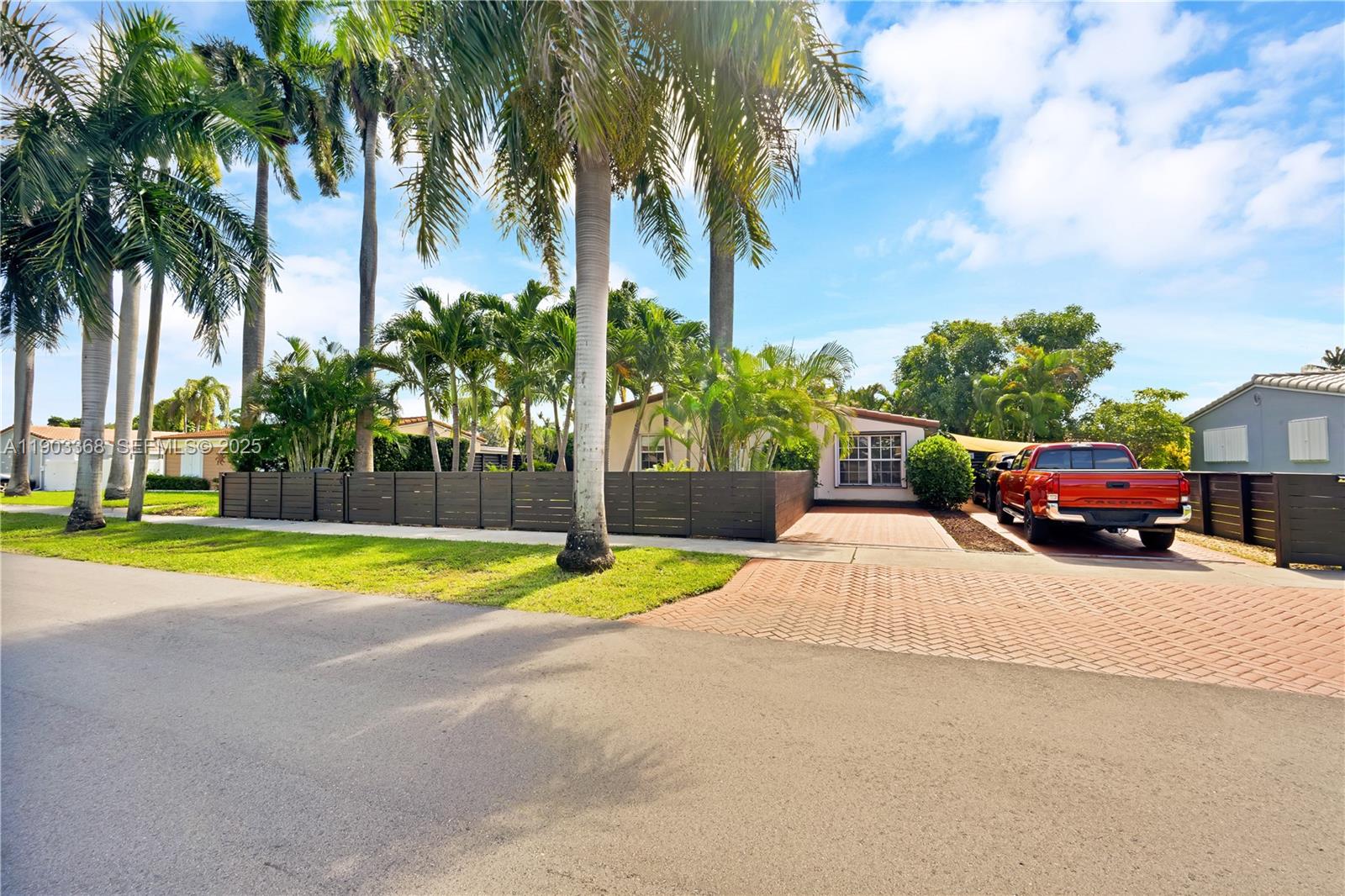 818 Northeast 3rd Street Hallandale Beach, FL 33009 - Photo 1 of 24 a swimming pool with a yard and palm trees