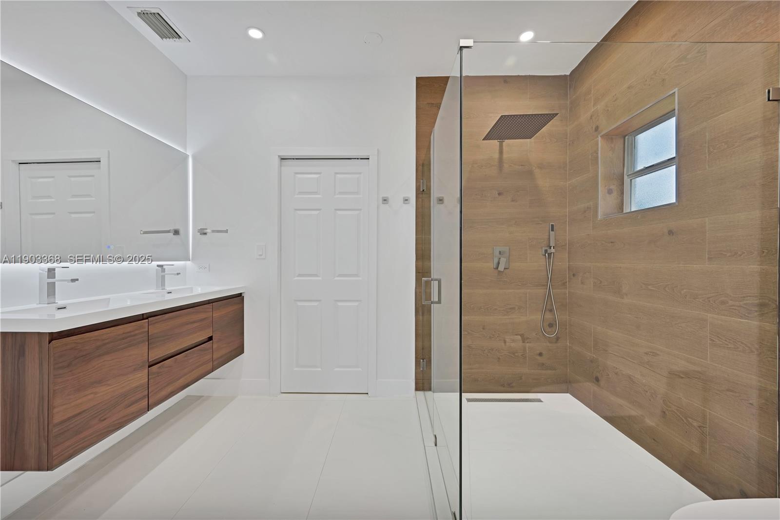 818 Northeast 3rd Street Hallandale Beach, FL 33009 - Photo 14 of 24 a spacious bathroom with a shower sink and mirror