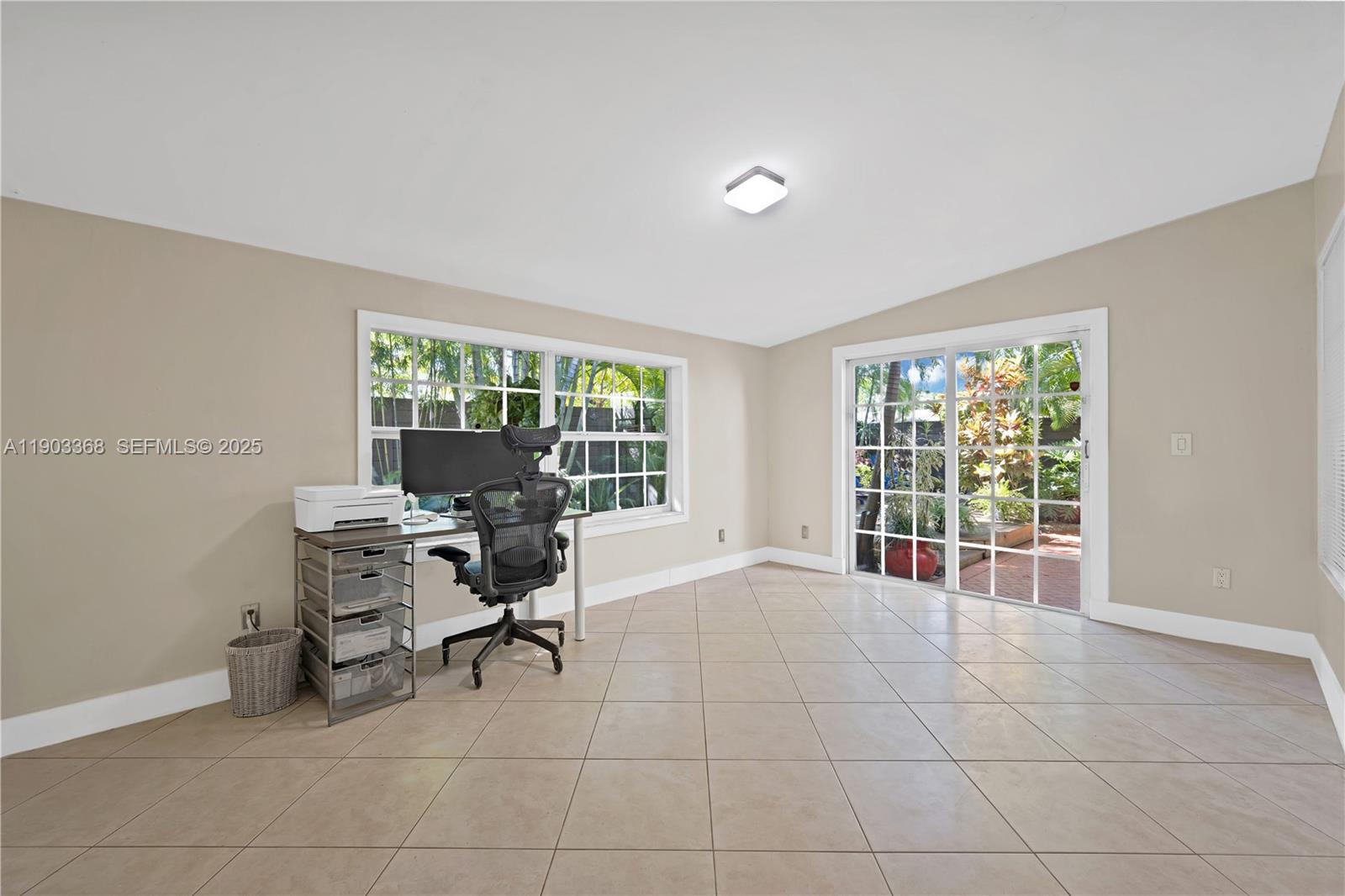 818 Northeast 3rd Street Hallandale Beach, FL 33009 - Photo 19 of 24 a view of a workspace with furniture and a window