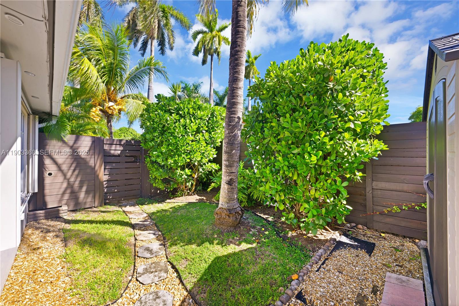 818 Northeast 3rd Street Hallandale Beach, FL 33009 - Photo 23 of 24 a view of a backyard with potted plants