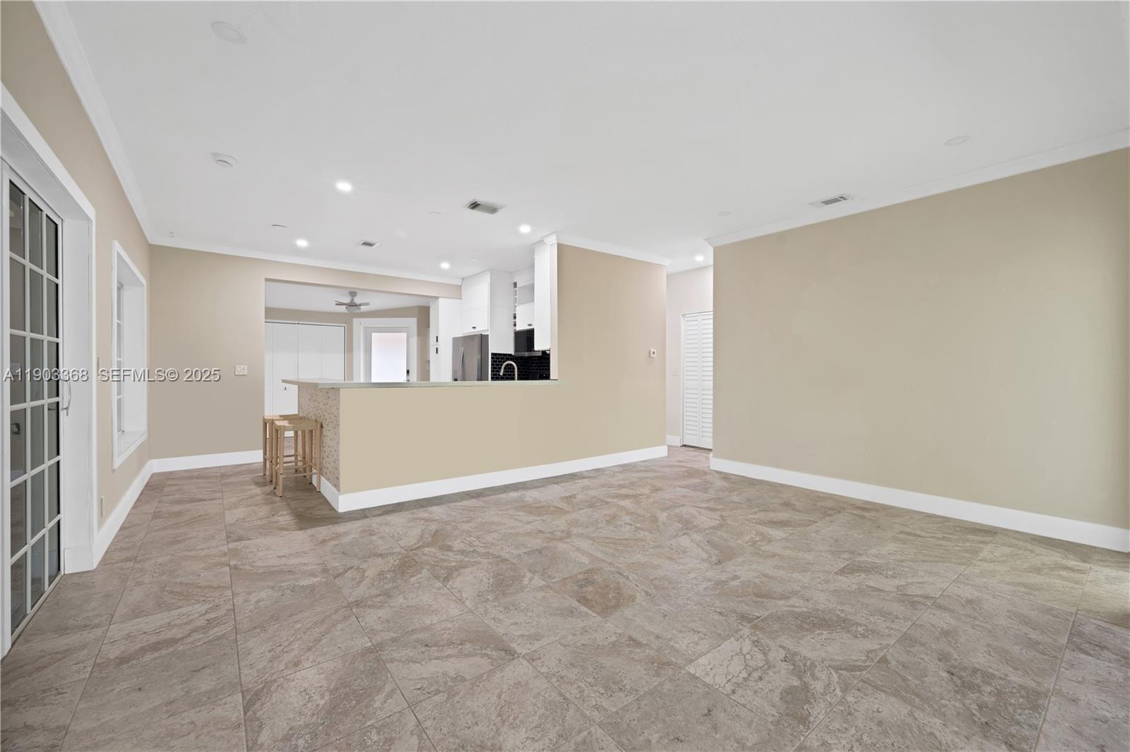 818 Northeast 3rd Street Hallandale Beach, FL 33009 - Photo 5 of 24 a view of an empty room with kitchen and a window