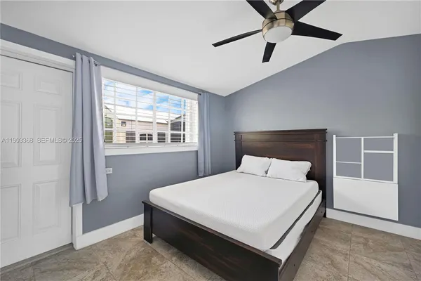 a bedroom with a bed and window