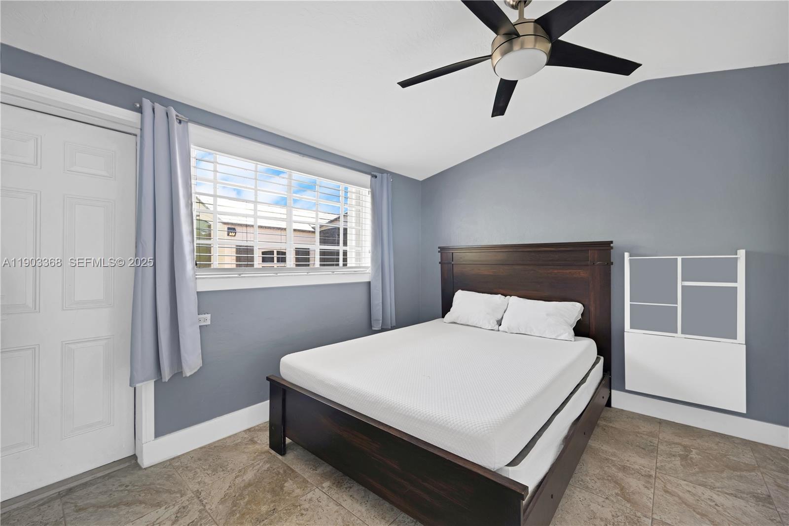 818 Northeast 3rd Street Hallandale Beach, FL 33009 - Photo 9 of 24 a bedroom with a bed and window