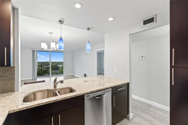 a kitchen with a sink cabinets and window