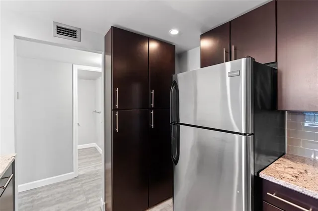 a white refrigerator freezer and a stove sitting inside of a kitchen