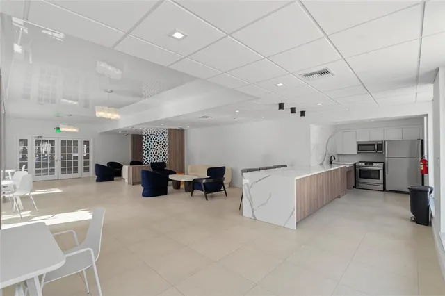 a large white kitchen with a large window