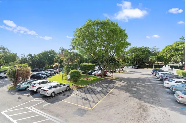 a view of a backyard with lawn chairs and a fire pit