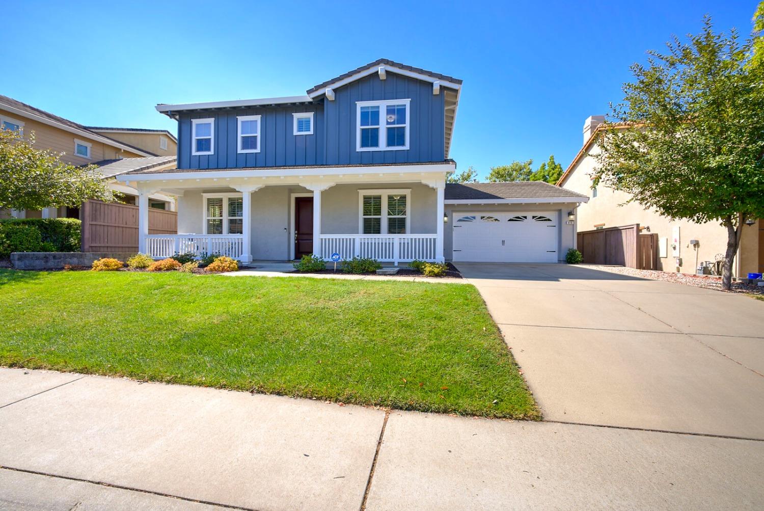 a front view of a house with a garden