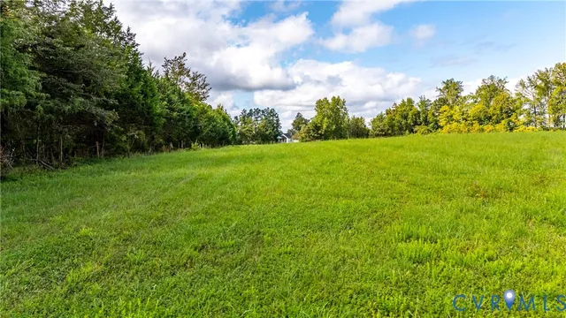 a view of field with trees in the background