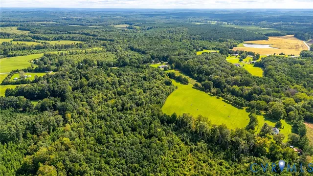 an aerial view of a house with a swimming pool outdoor seating and mountains