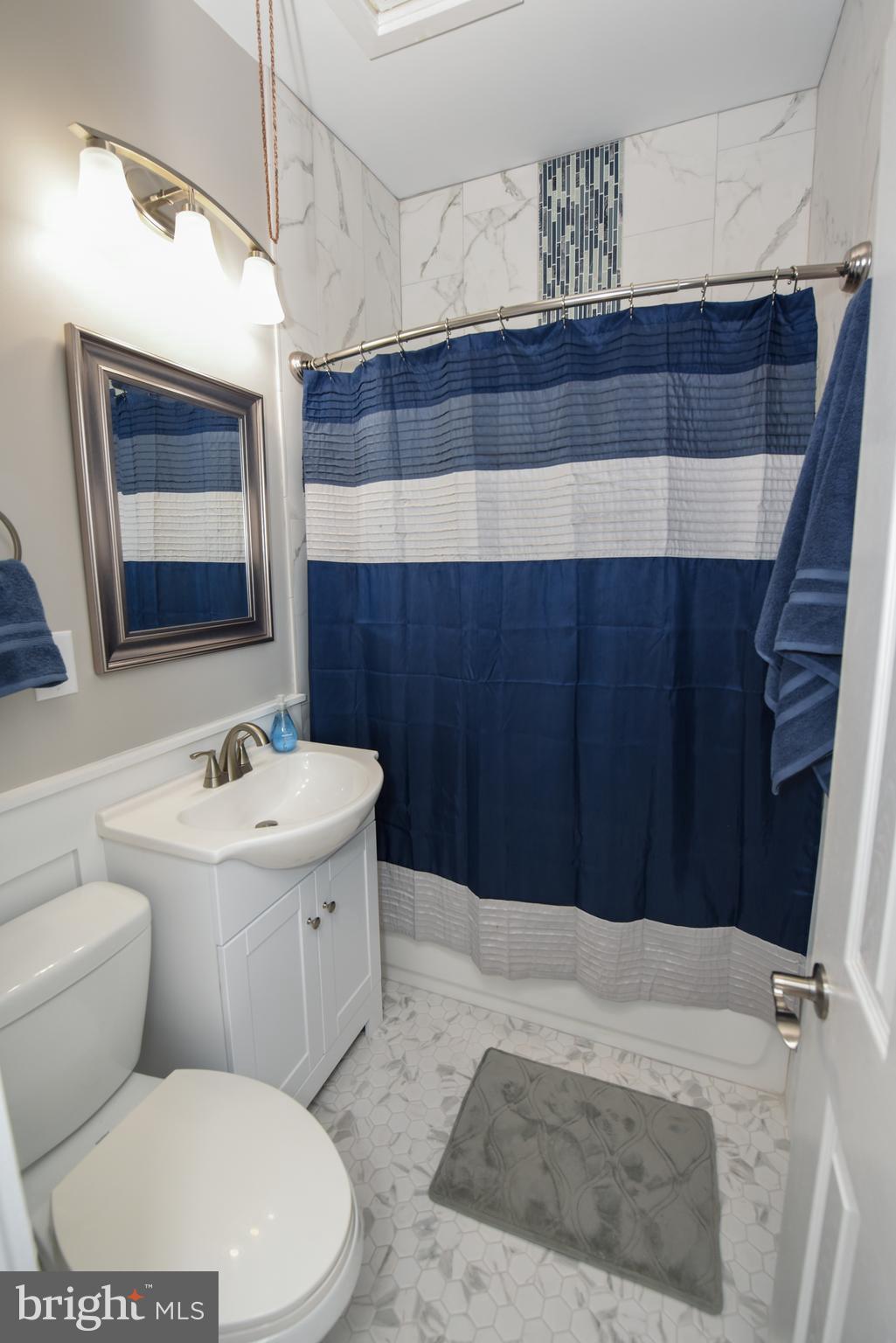 9332 Rising Sun Avenue Philadelphia, PA 19115 - Photo 22 of 27 a bathroom with a sink a toilet and mirror