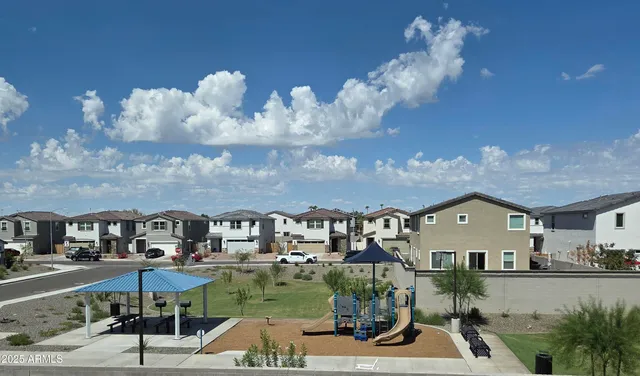 a view of multiple houses with a street