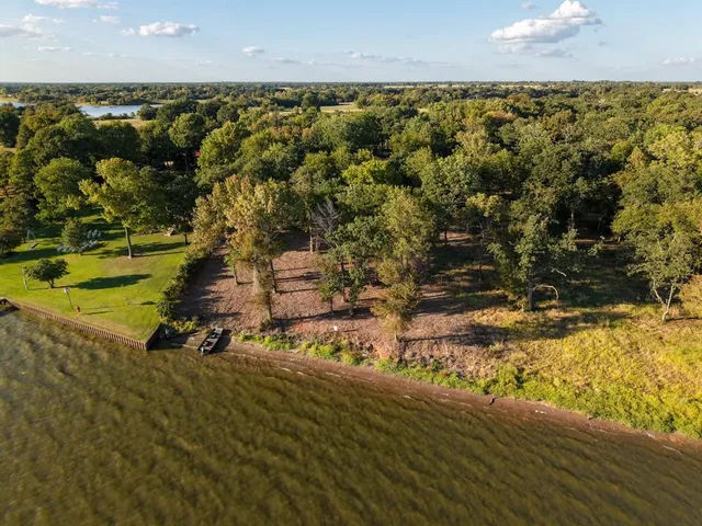 a view of a lake in middle of forest