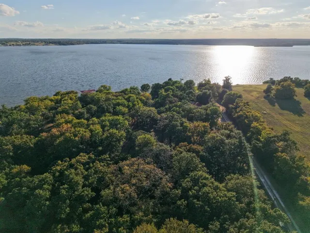 a view of a lake with a garden and mountain view